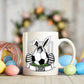 Mug with a soccer ball design featuring a bunny and eggs, surrounded by Easter decorations.