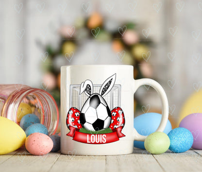 Mug with a soccer ball and bunny design, surrounded by Easter eggs and decorations.